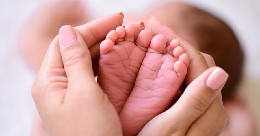 Baby's feet in mother's hands