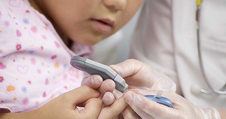 Finger-prick blood test on child