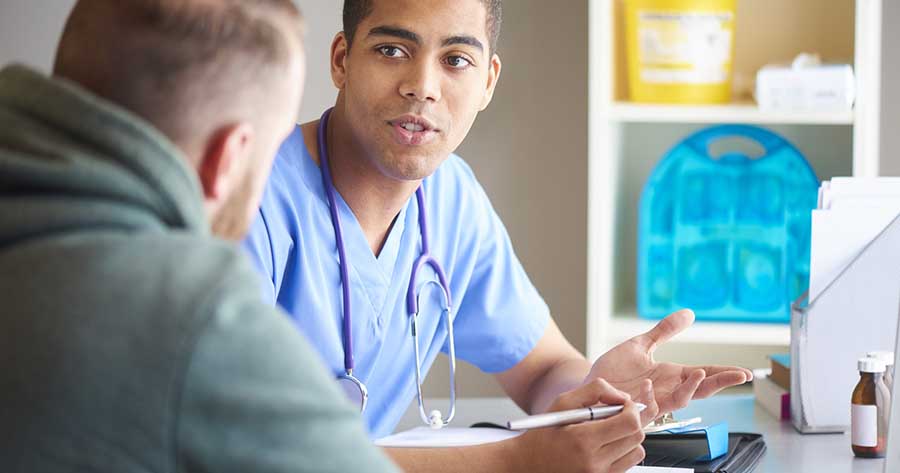 Healthcare professional in consultation with patient.