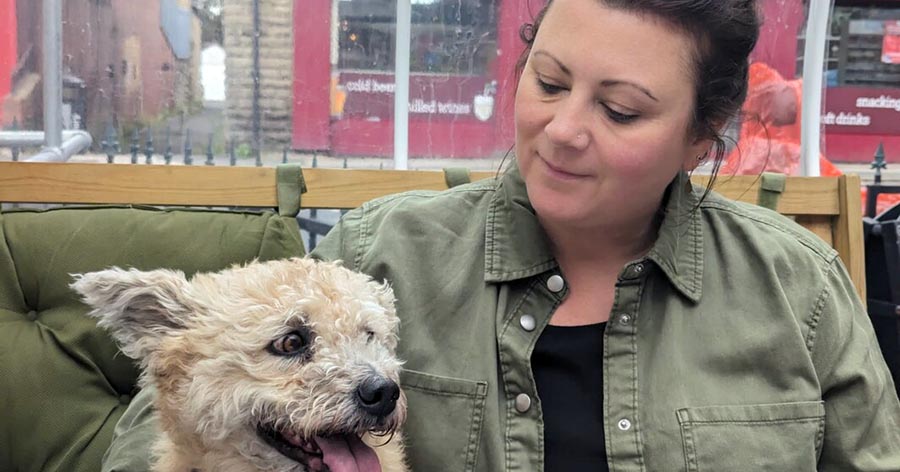 Woman with dog in cafe.