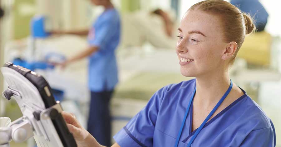 Nurse using screen on ward