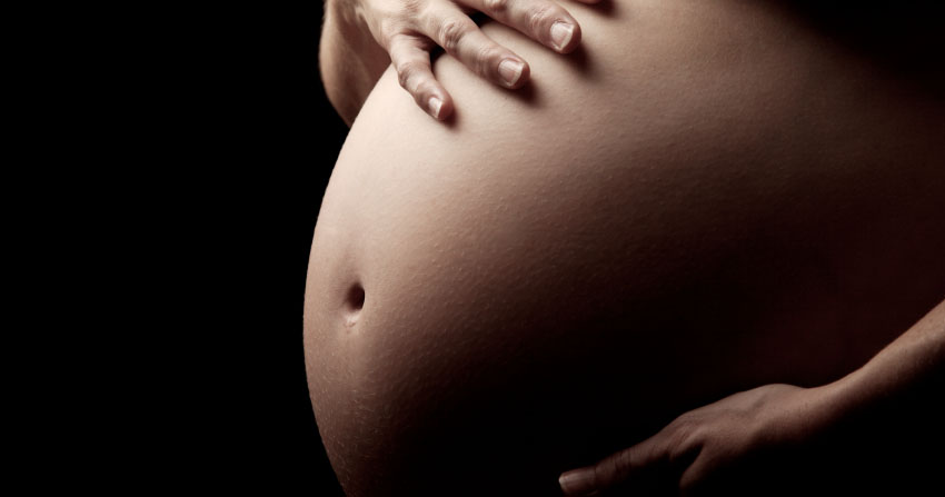 Photo of a pregnant woman's stomach.