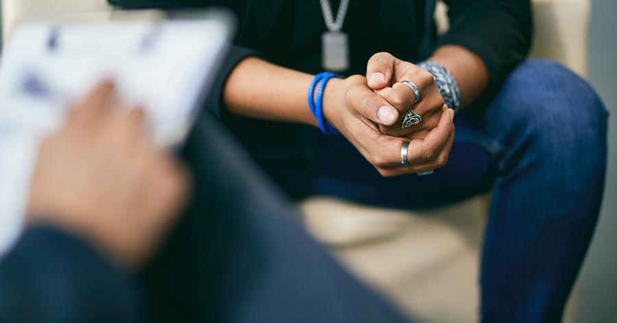View of teenager's hands during a consultation